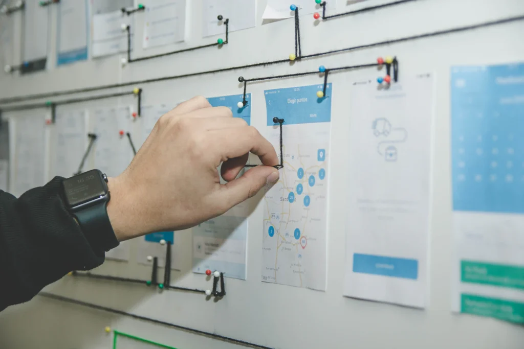 Person mapping out a workflow on a board