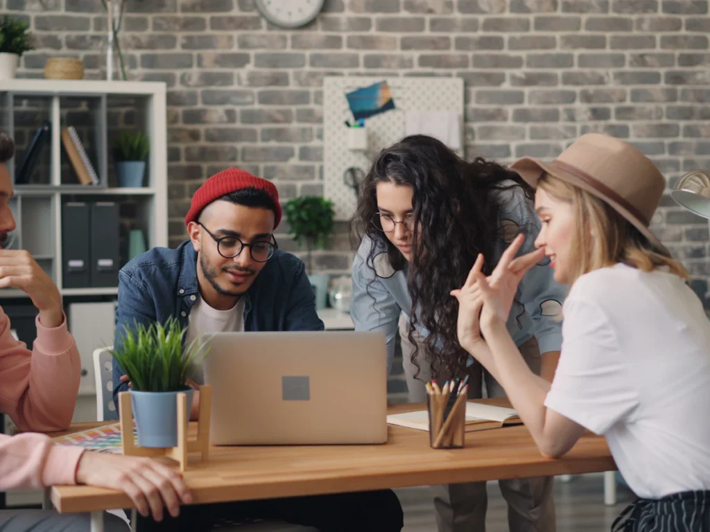Small team working together around a laptop